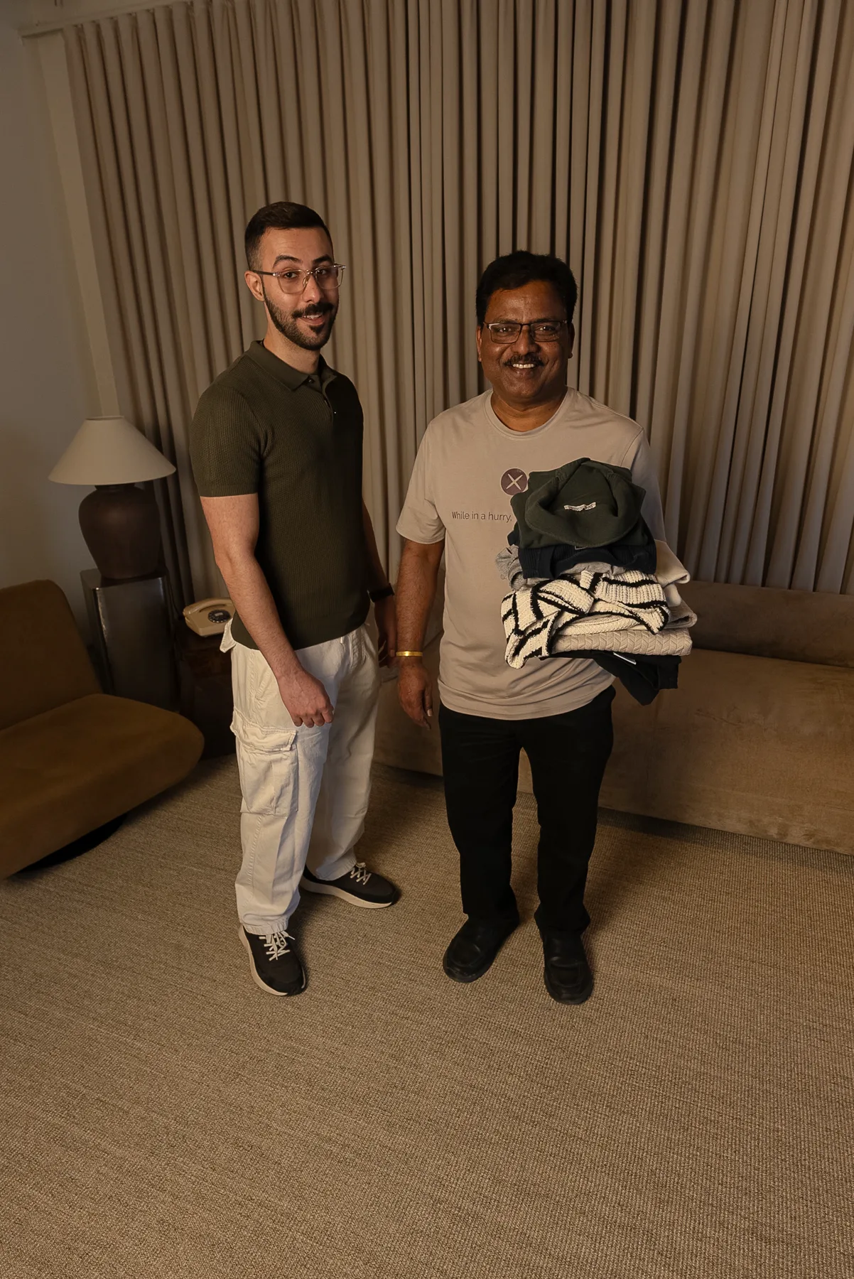 A Tailor Express home-service delivery, freshly altered garments in hand.